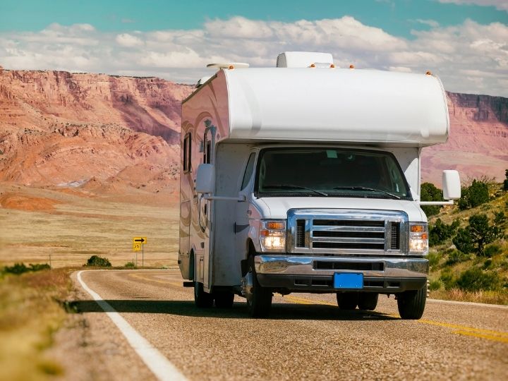 Friendly Houston RV repair team standing beside service van with tools